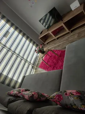 a bedroom with a couch and a large window at Oroklini, Cyprus in Voroklini