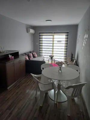 a living room with a table and chairs and a couch at Oroklini, Cyprus in Voroklini