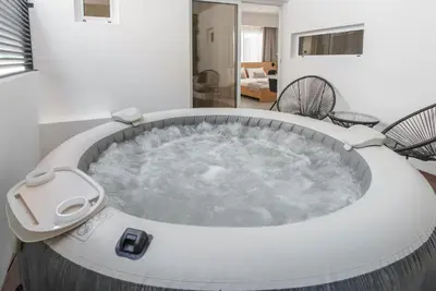 a jacuzzi tub in the middle of a room at Kition Urban Suite 2 in Larnaka
