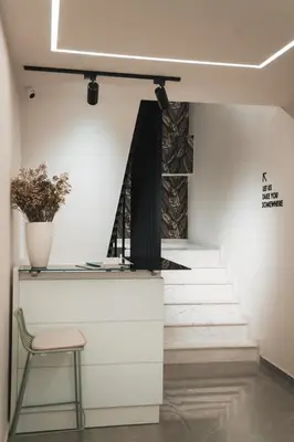 a chair sitting next to a counter with stairs at Kition Urban Suite 2 in Larnaka