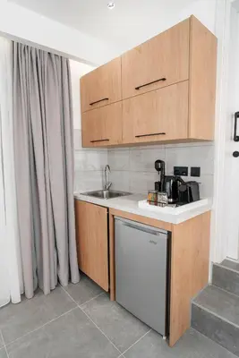 a small kitchen with a sink and a dishwasher at Kition Urban Suite 2 in Larnaka
