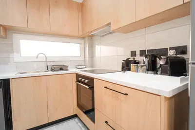 a kitchen with a sink and a stove at Kition Urban Suite 1 in Larnaka