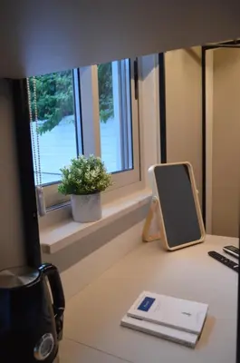 a desk with a mirror on a desk with a window at LEONDIANA Boutique Hotel in Larnaka