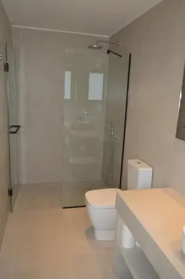 a bathroom with a toilet and a glass shower at LEONDIANA Boutique Hotel in Larnaka