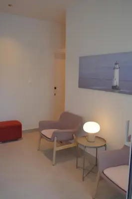 a room with two chairs and a table and a lighthouse at LEONDIANA Boutique Hotel in Larnaka