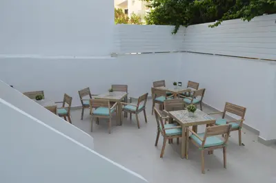 a group of tables and chairs on a patio at LEONDIANA Boutique Hotel in Larnaka