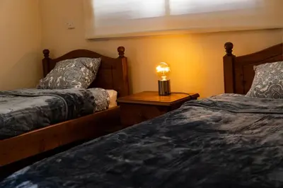 a bedroom with two beds and a lamp on a table at Villa Alexander The Great in Protaras