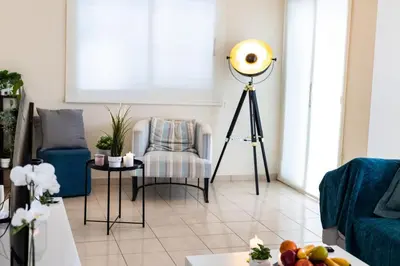 a living room with a floor light on a tripod at Villa Alexander The Great in Protaras