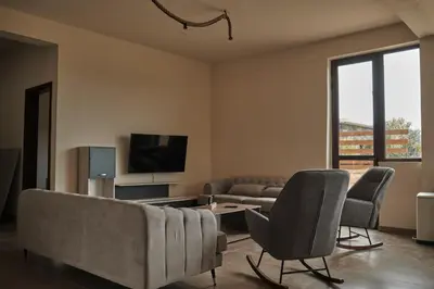 a living room with a couch and chairs and a tv at Kleos Noble Retreat - Private Estate in Limassol