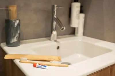 a bathroom sink with a toothbrush at SuiteNapa22 in Ayia Napa