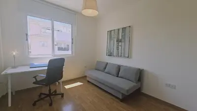 a room with a couch and a desk and a chair at STAY Space View Apartment in Nicosia