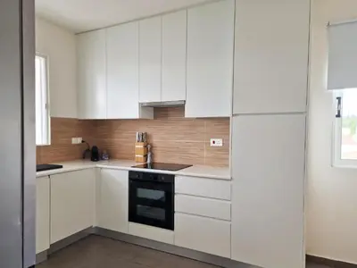 a kitchen with white cabinets and a stove at STAY Space View Apartment in Nicosia