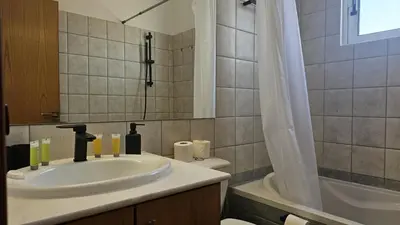 a bathroom with a sink and a toilet and a tub at STAY Space View Apartment in Nicosia