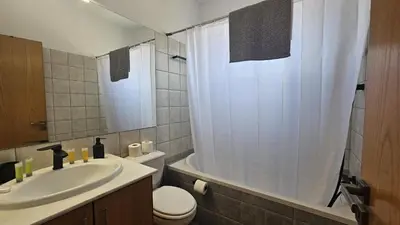 a bathroom with a sink and a toilet and a shower at STAY Space View Apartment in Nicosia