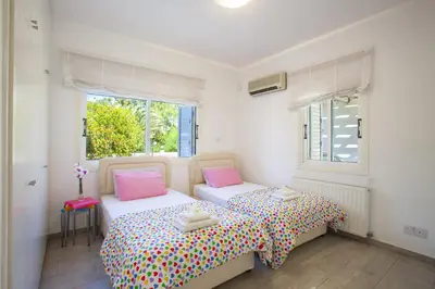 a bedroom with two beds and a window at Luxury Villa With Special Sea Views in Meneou