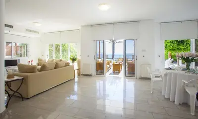 a living room with a couch and a table at Luxury Villa With Special Sea Views in Meneou