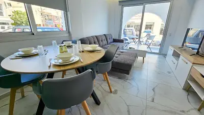a dining room with a table and chairs in a room at Urban Comfort Apartment in Larnaka