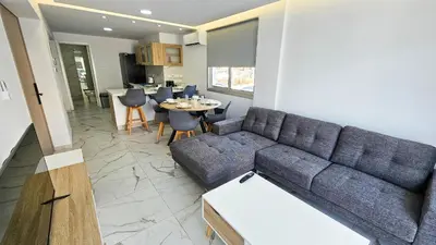 a living room with a couch and a table at Urban Comfort Apartment in Larnaka