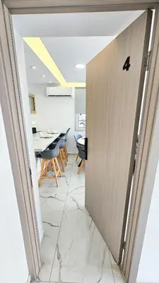 a door leading into a dining room with a table at Urban Comfort Apartment in Larnaka