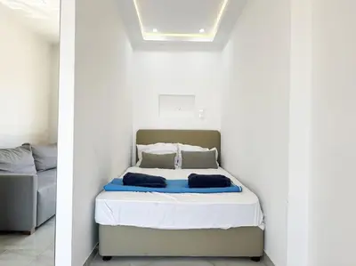 a white bedroom with a bed in a room at Alice Studio Holiday Apartment - Ayia Napa in Ayia Napa