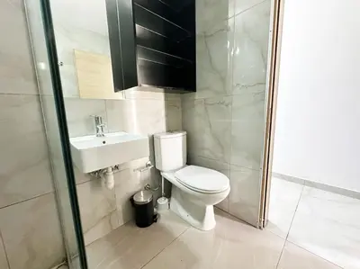 a bathroom with a toilet and a sink and a shower at Alice Studio Holiday Apartment - Ayia Napa in Ayia Napa