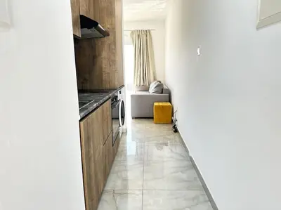 a hallway with a kitchen and a living room at Alice Studio Holiday Apartment - Ayia Napa in Ayia Napa