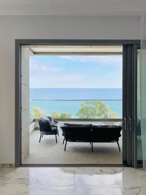 a sliding glass door with a view of a patio at The Address -Beachfront 2 Bedroom Residence in Limassol