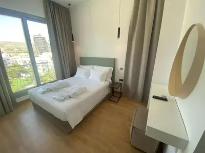 a bedroom with a bed with towels on it at The Address -Beachfront 2 Bedroom Residence in Limassol
