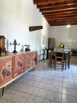 a dining room with a table and a dresser at Villa Christothea in Paphos