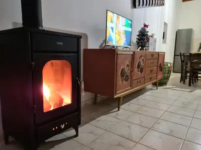 a wood burning stove in a living room with a tv at Villa Christothea in Paphos