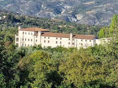 a large building on top of a hill with trees at Villa Christothea in Paphos