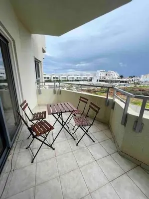 two chairs and a table on a balcony with a view at Niove Budget One-Bedroom Apartment in Paralimni