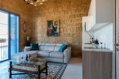 a living room with a couch and a table at Le Voyageur By the Sea - Furnished Rooms in Larnaka