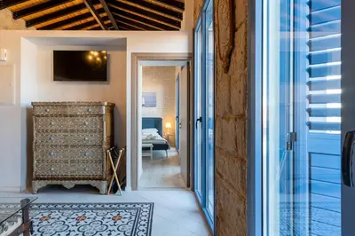 a hallway with a door to a room with a bedroom at Le Voyageur By the Sea - Furnished Rooms in Larnaka