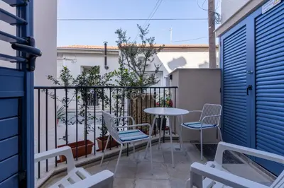 a balcony with chairs and a table on a balcony at Le Voyageur By the Sea - Furnished Rooms in Larnaka
