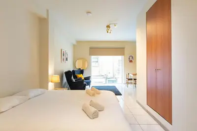 a bedroom with a bed with two stuffed animals on it at Charming studio with reading nook & city view in Nicosia