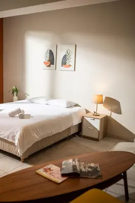 a bedroom with a bed and a coffee table at Spacious studio located in the pedestrian zone in Nicosia