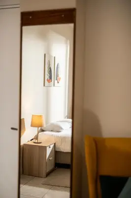 a bedroom with a bed and a mirror at Spacious studio located in the pedestrian zone in Nicosia