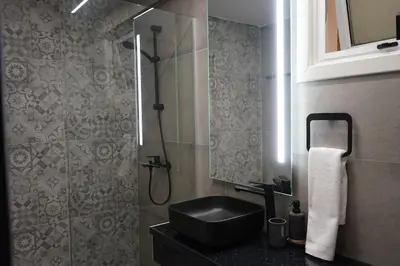 a bathroom with a black sink and a shower at Lazuli Urban Luxury -2 bedroom with Pool in Larnaka