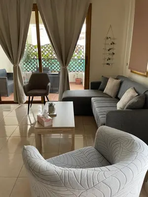 a living room with two couches and a table at Seascape apartment in Larnaka