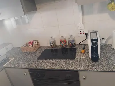 a kitchen counter with a stove and a phone on it at Irenes Apartment in Larnaka