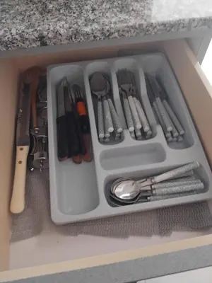 a drawer filled with utensils in a cabinet at Irenes Apartment in Larnaka