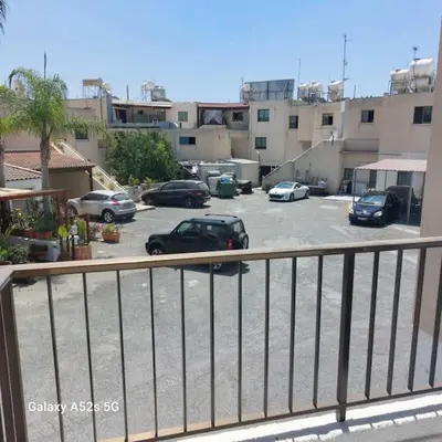 a parking lot with cars parked in a parking lot at Irenes Apartment in Larnaka