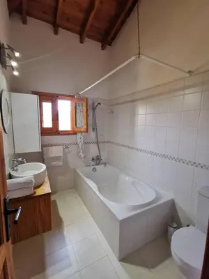 a bathroom with a tub and a sink and a toilet at Wedding Unique Villa in Larnaka