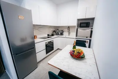 a kitchen with a bowl of fruit on a table at TG NEW Luxury Private Resort & SPA Villas - Heated Salty Swimming Pool, Outdoor Jacuzzi, Sauna, Exotic Garden in Limassol