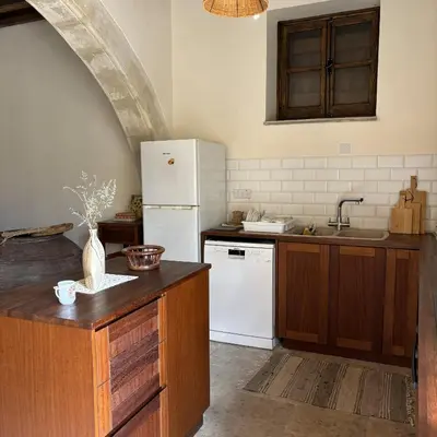 a kitchen with a white refrigerator and a sink at Levanda House - Traditional House Vasa Koilaniou in Vasa Kilaniou