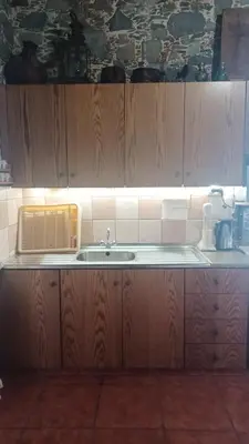 a kitchen with wooden cabinets and a sink at George's House in Askas