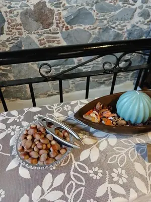 a table with two plates of food and a bowl of nuts at George's House in Askas