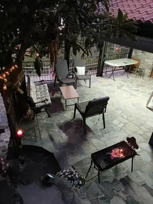 a patio with couches and a fire place at George's House in Askas