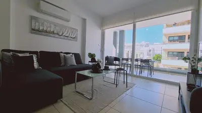 a living room with a couch and a table at STAY Novel Apartment in Larnaka